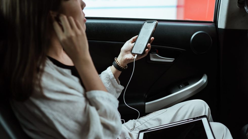 passenger listening to music on her phone