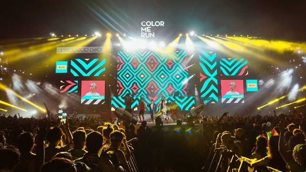 people cheering for a group performing on stage