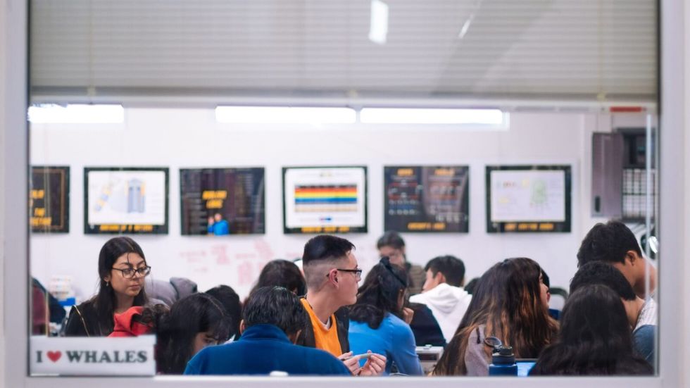 people seated in a white room