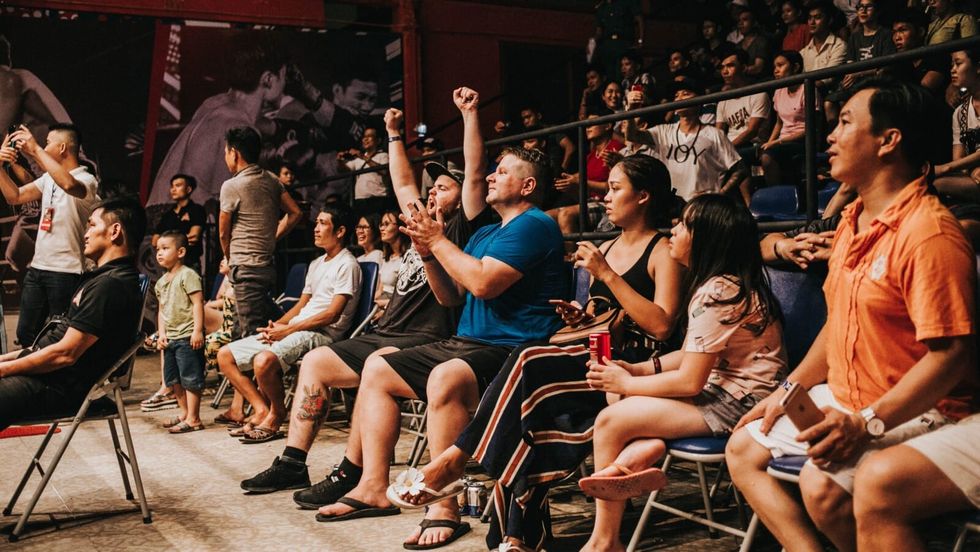 people sitting in chairs and cheering