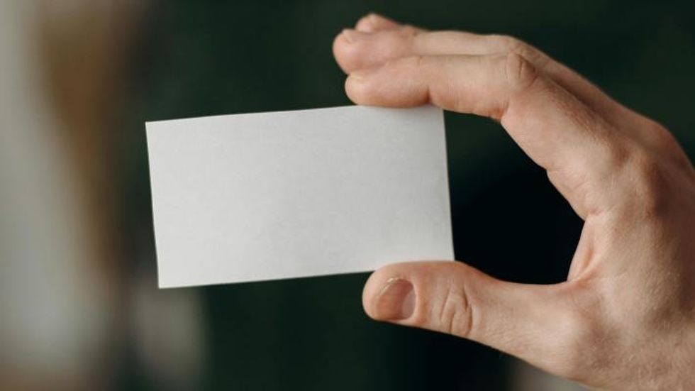 person holding a blank card 