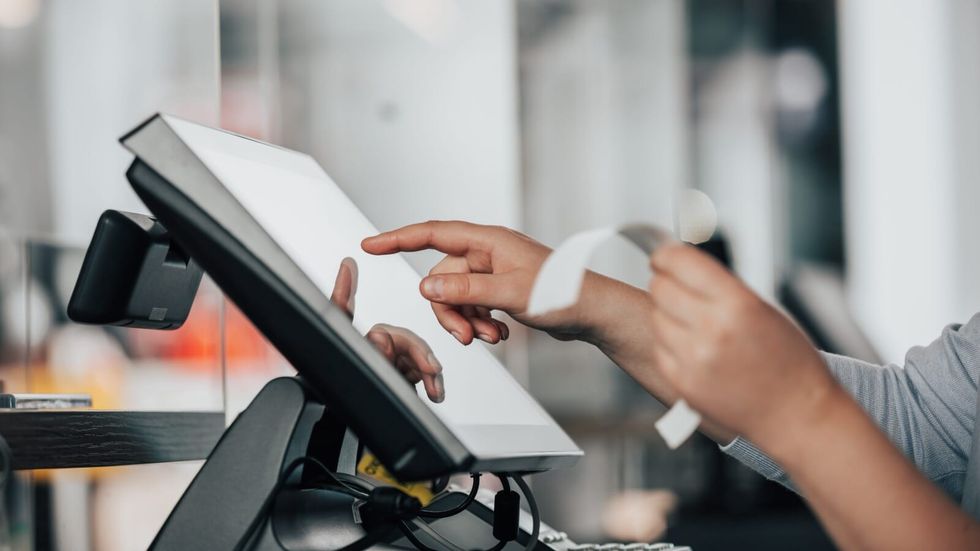 person holding a restaurant bill