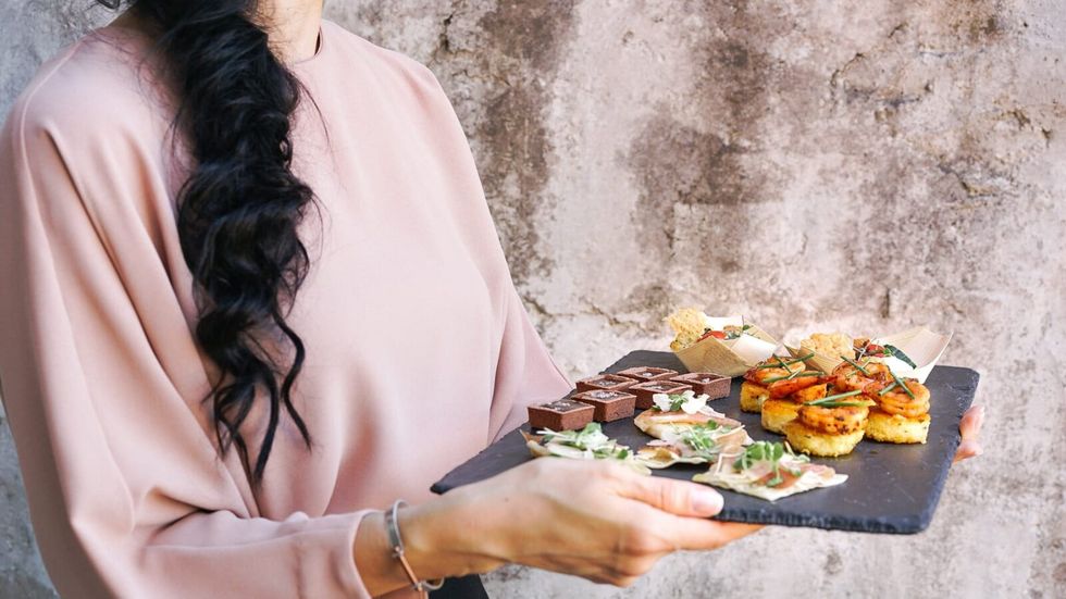 person holding a tray of food