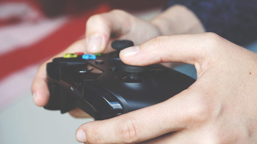 person holding an gaming console