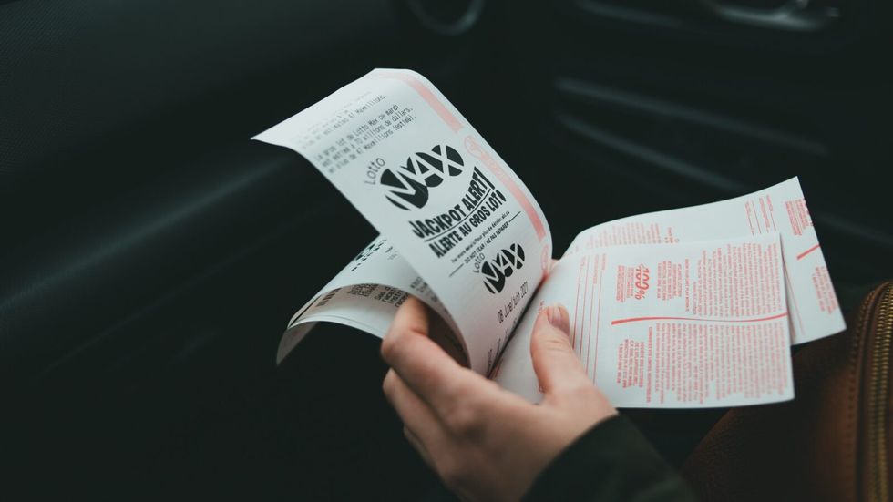 person holding lottery tickets