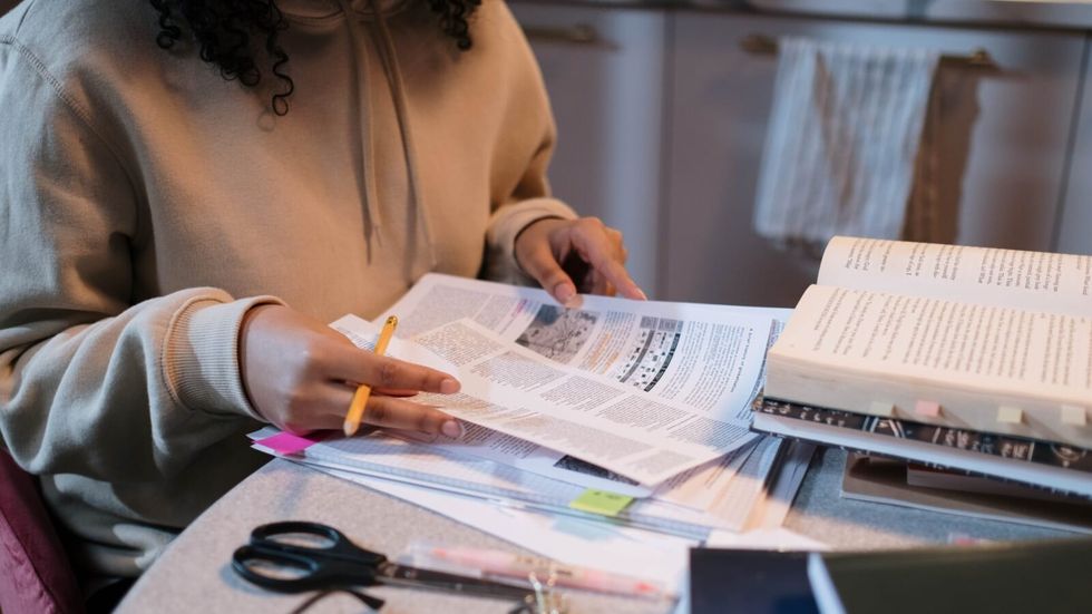 person studying papers for an exam