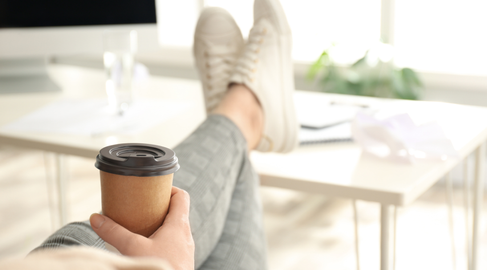 person with feet on desk