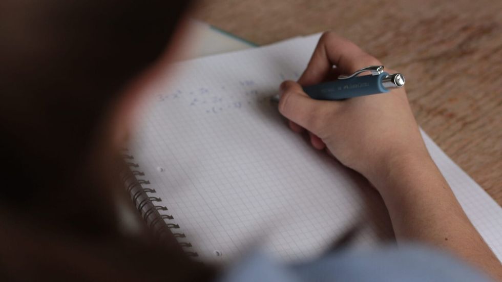person writing in a notebook