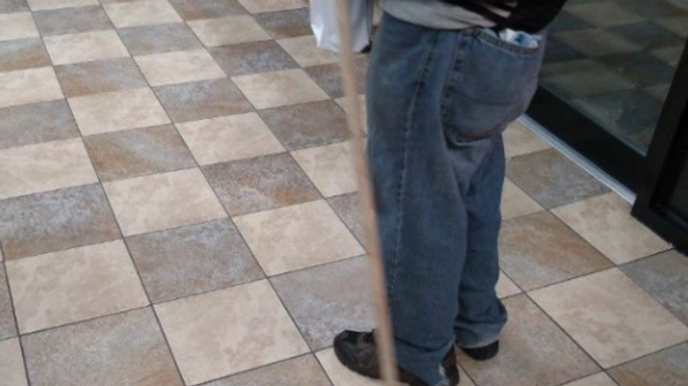 photo of a person's jeans and shoes