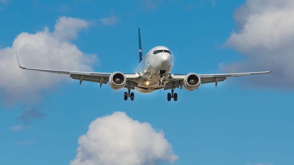 plane flying in a clear blue sky