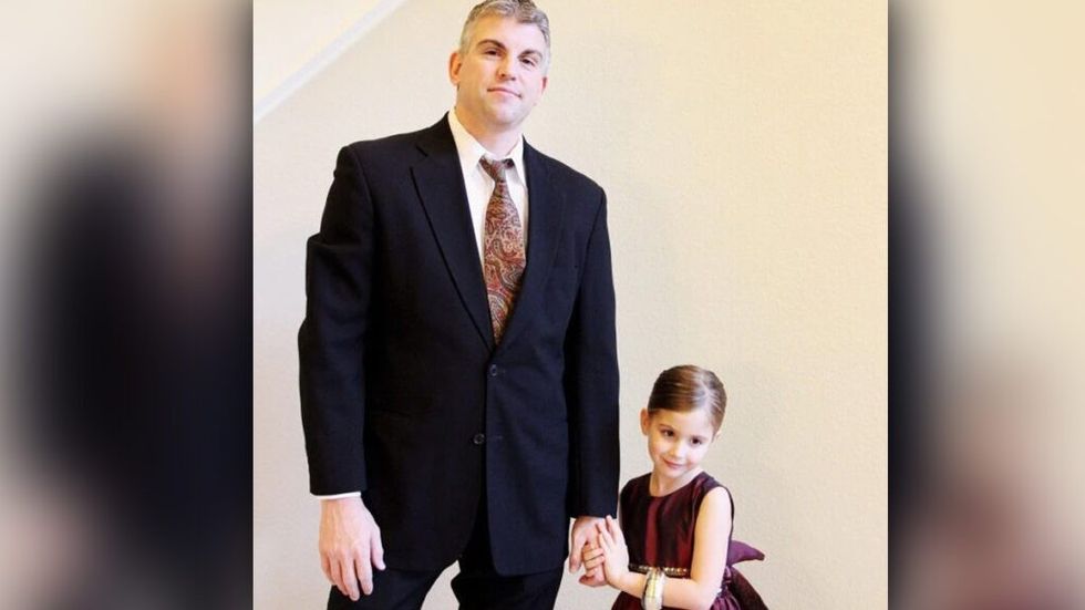 Police officer stands with dead partner's daughter for special dance