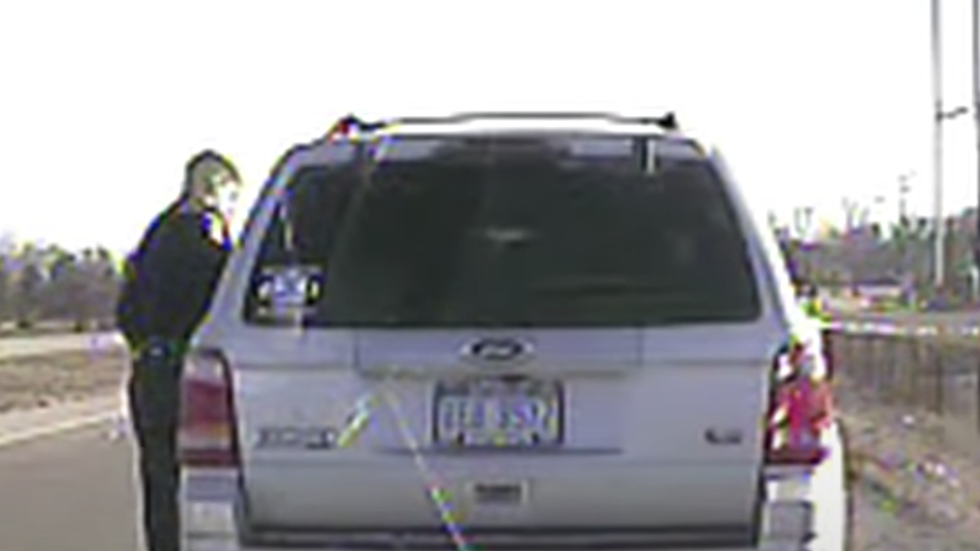 police officer talking to someone in a car