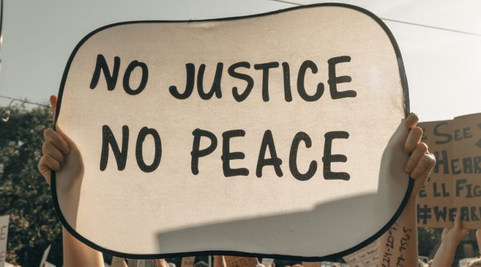 Protest snapshot with the sign No Justice, No Peace