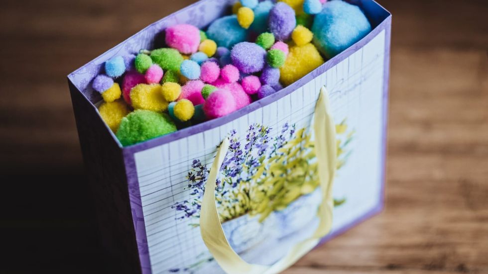 purple gift bag with multicolored confetti