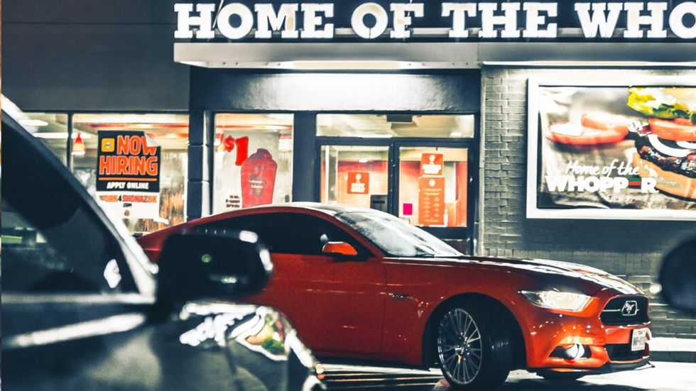 Red Ford Mustang in front of a Burger King