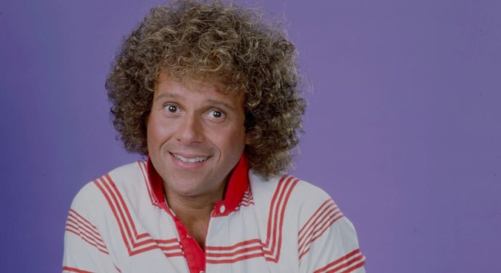 Richard Simmons young wearing a striped red and shite t-shirt.