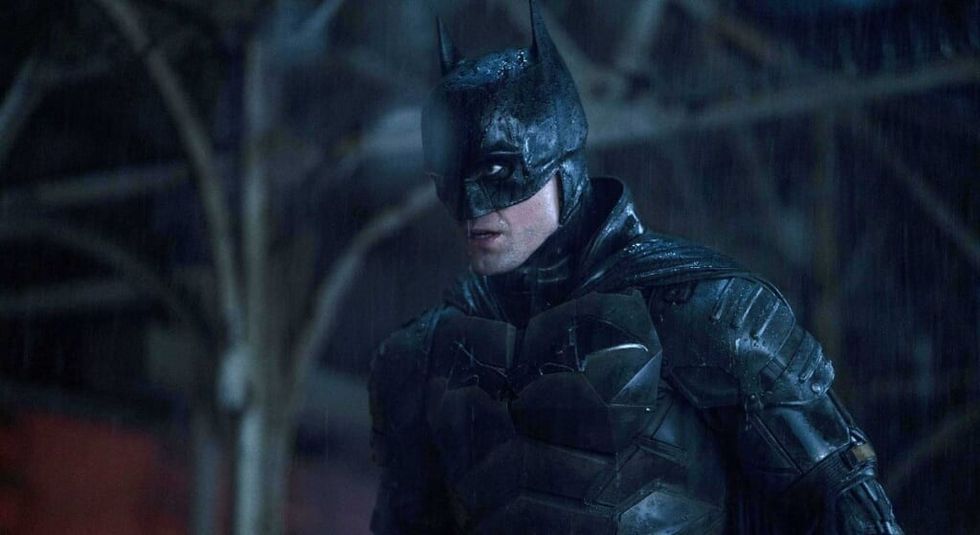 Robert Pattinson as Batman, in bat suit staring grimly off camera.