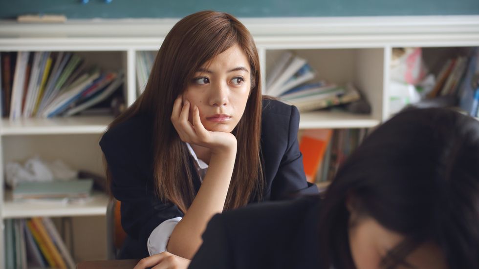 sad student staring with head in her hands