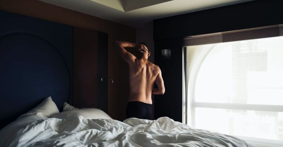 shirtless person in their bedroom