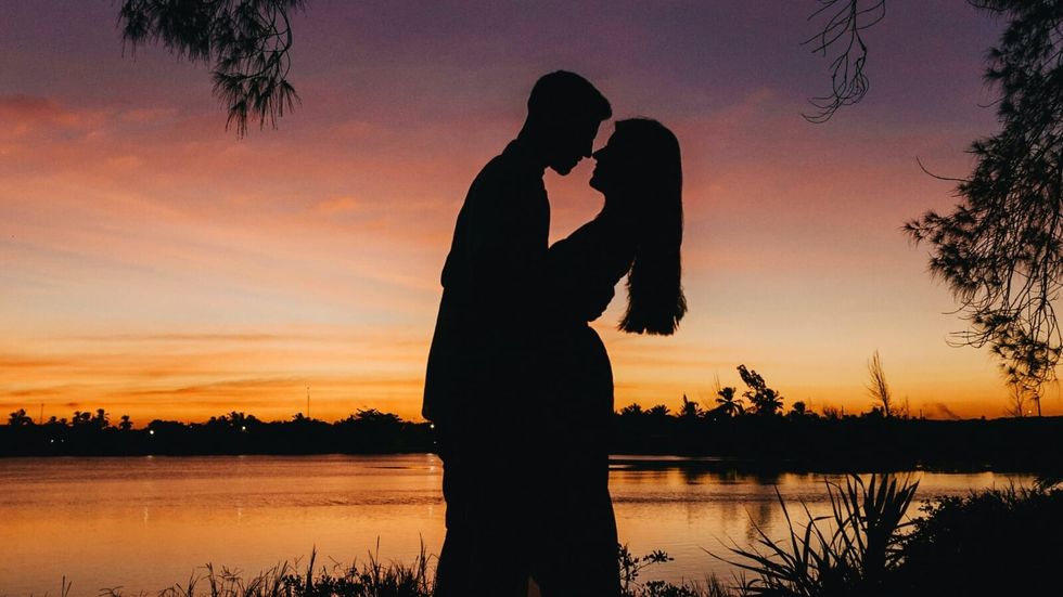 silhouette of a man and woman hugging
