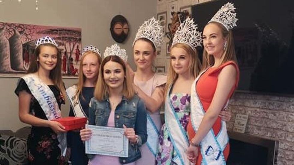 six girls wearing dresses and crowns