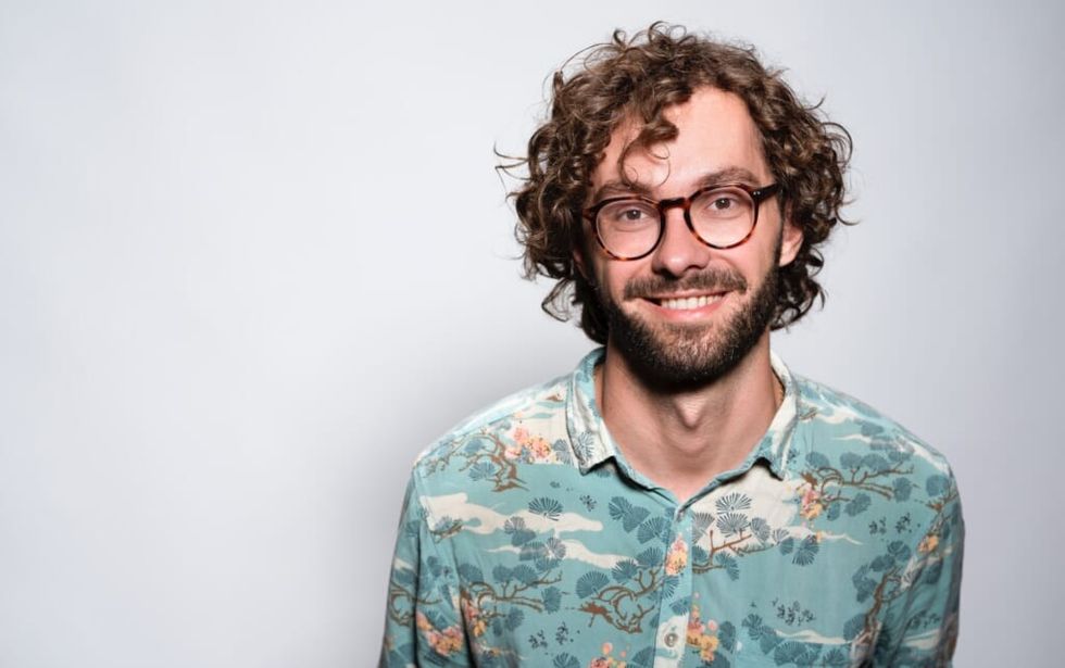 smiling confident young man wearing glasses