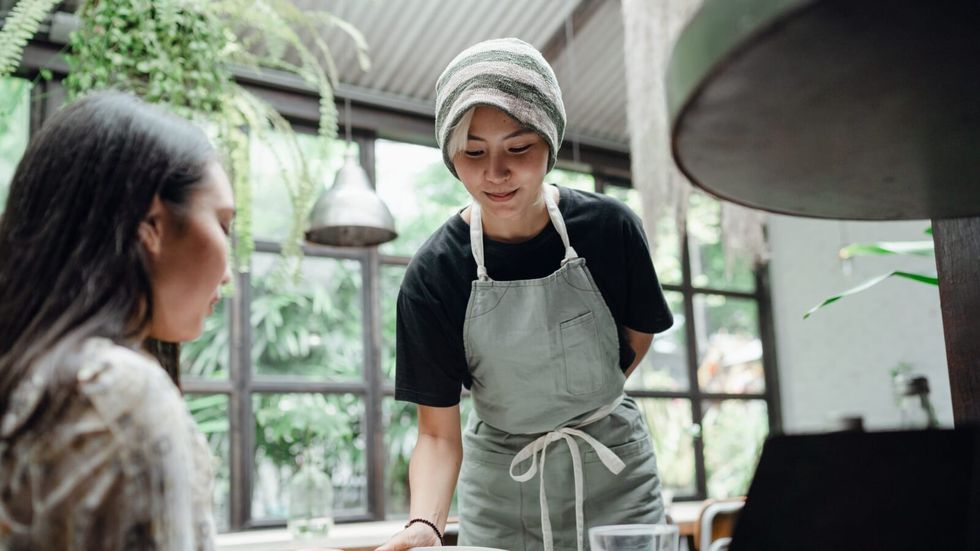 smiling waitress serving customer