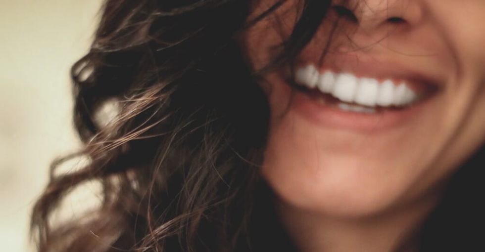 smiling woman's face her eyes are not seen