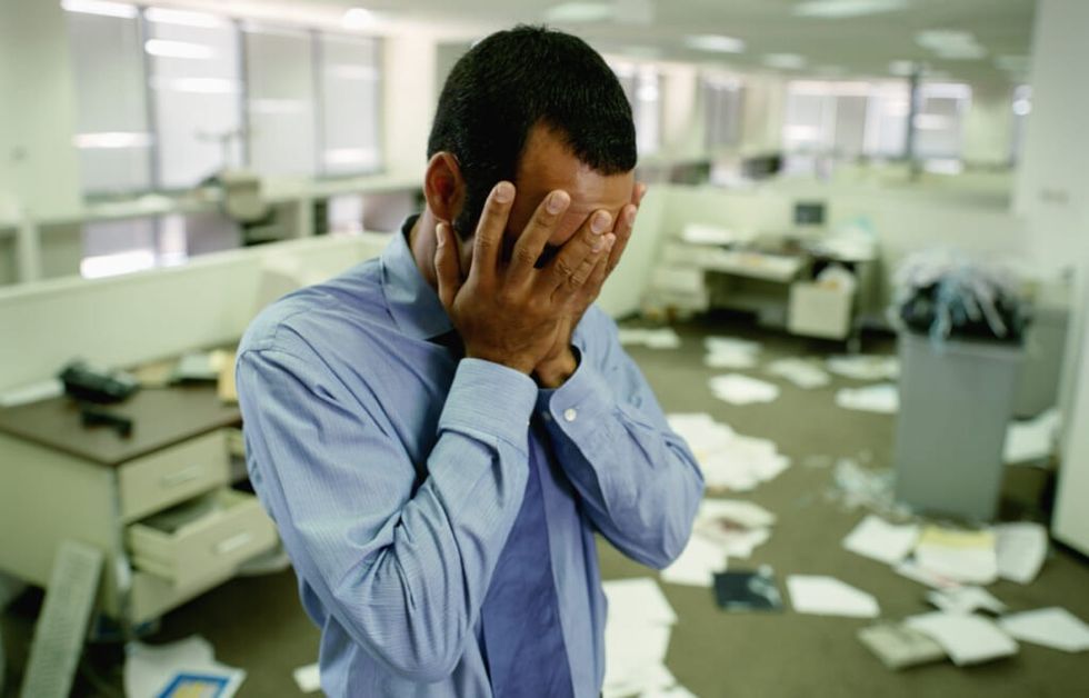 Stressed Businessman in Messy Office