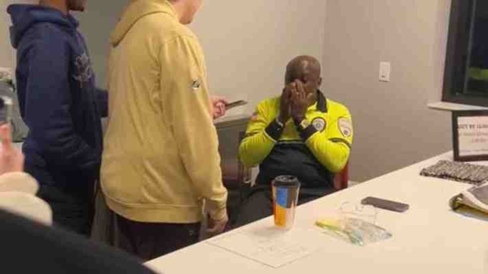 students handing something to a shocked man