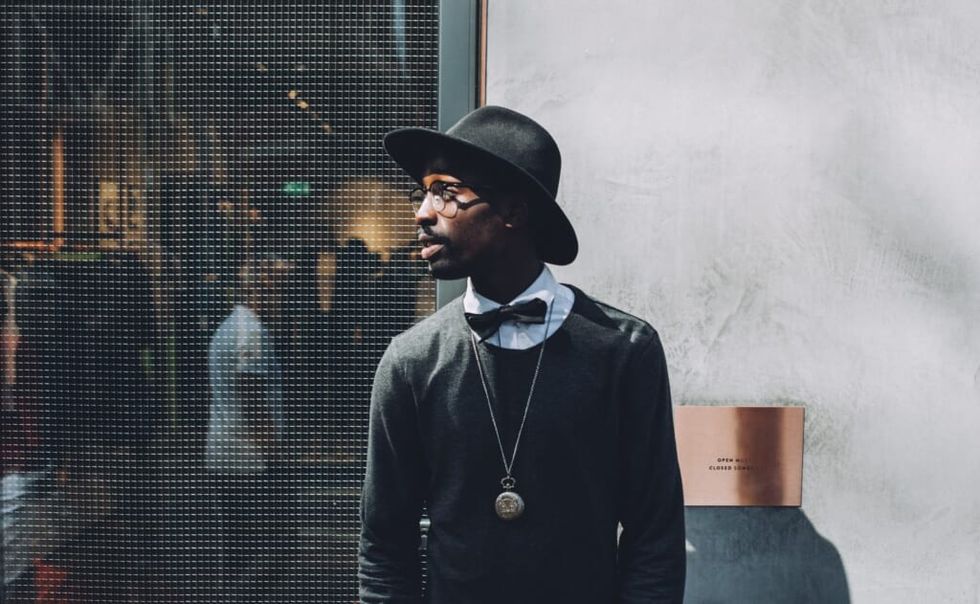 stylish man poses outside