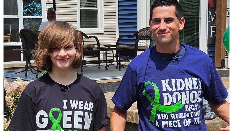 teen boy standing with adult male teacher