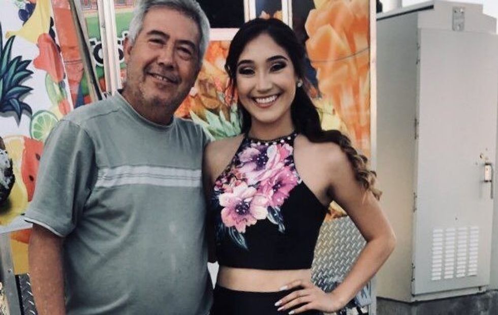 teenage girl in a prom dress, standing next to her father