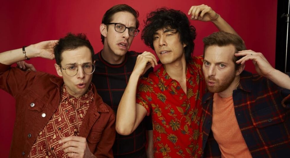 The Try Guys posing in front of a red screen.