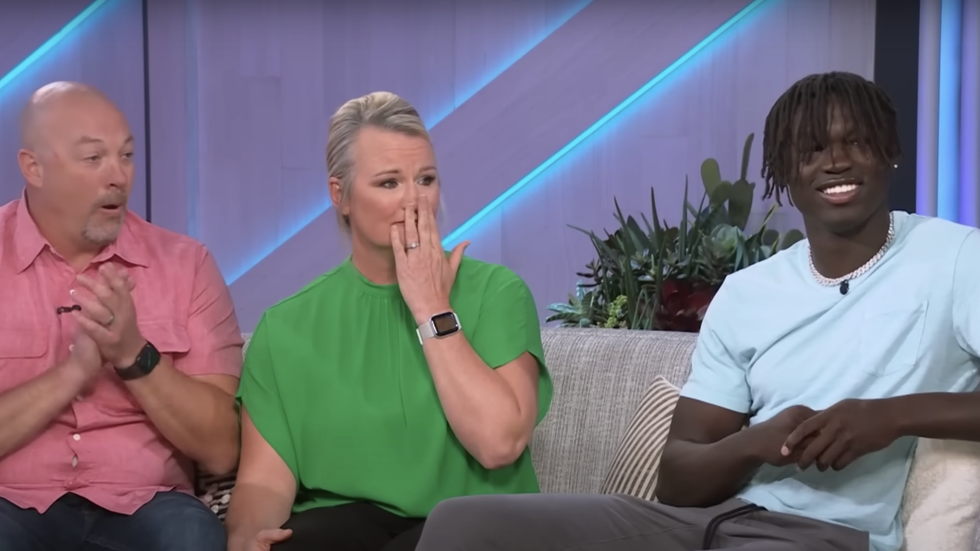 three people sitting on a couch