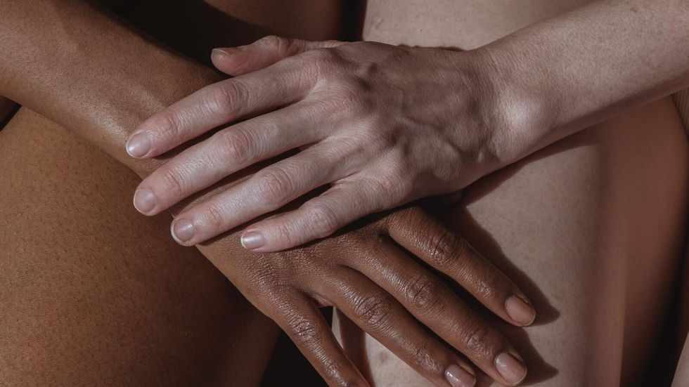 two diverse people holding hands