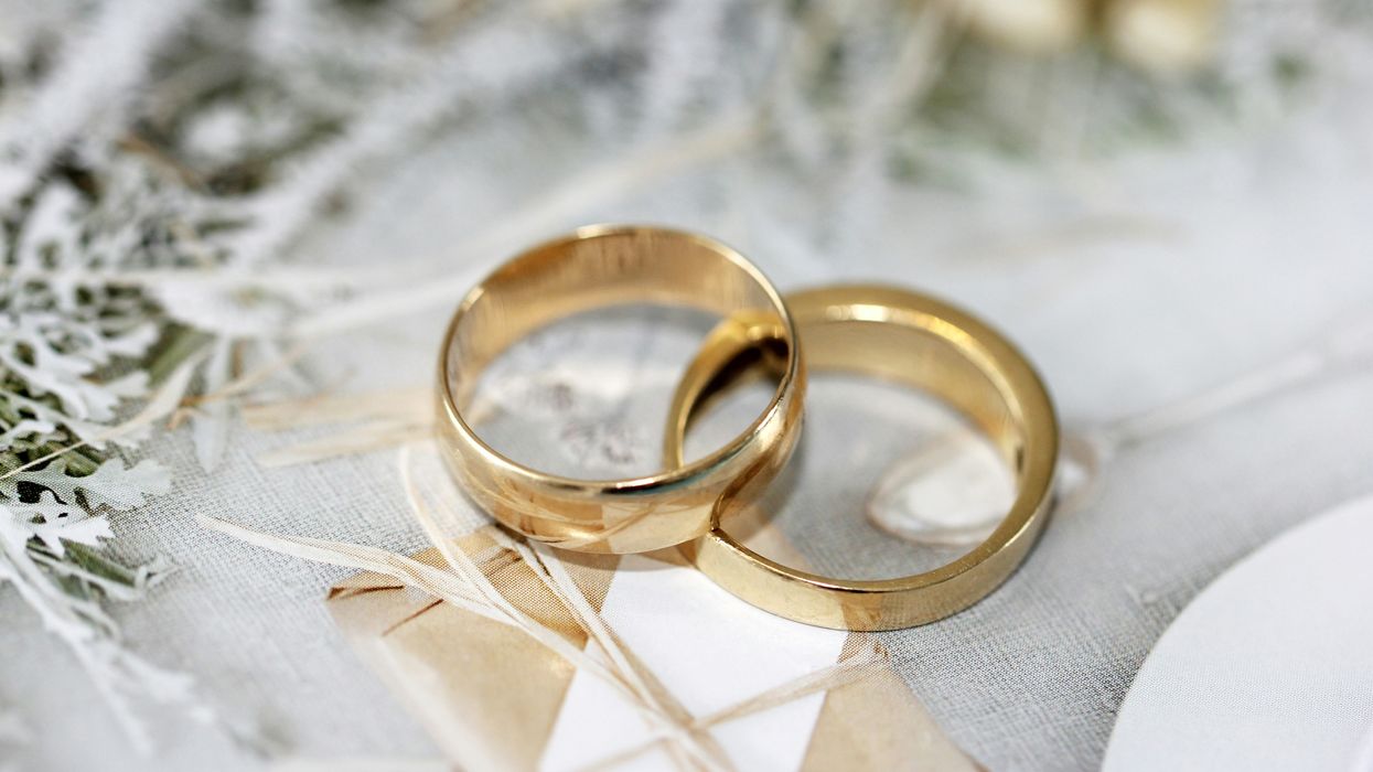 Two gold wedding bands intertwined