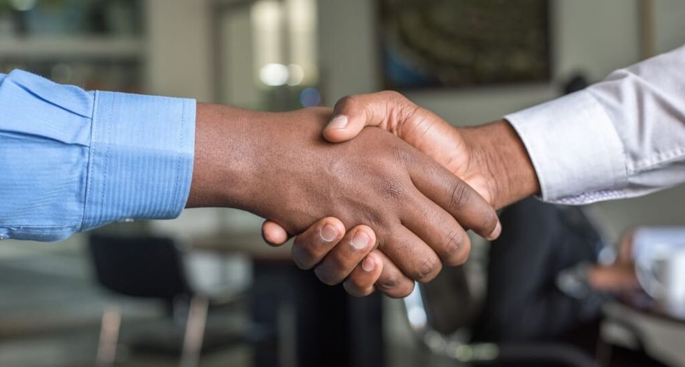 two male hands shake hands