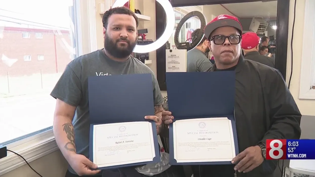 Two men holding certificates