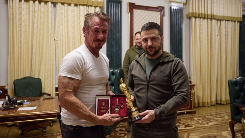 two men standing together wiith awards in their hands