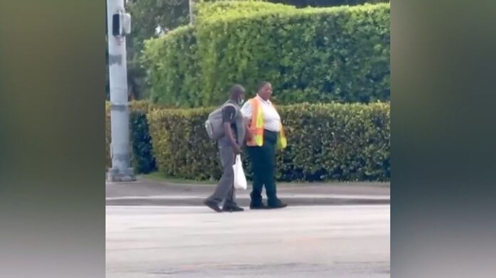 two people crossing the street