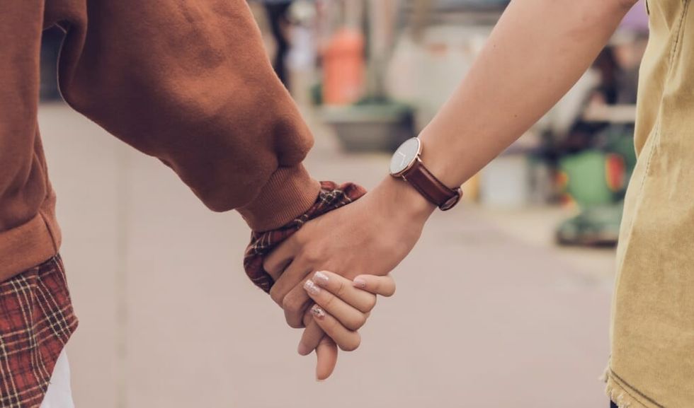 two people holding hands