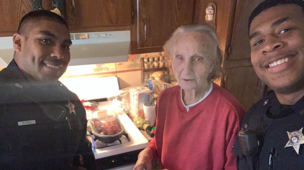 two police officers with elderly woman