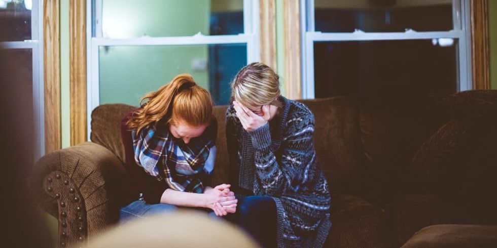 Two sad women sitting on couch by Ben White on Unsplash