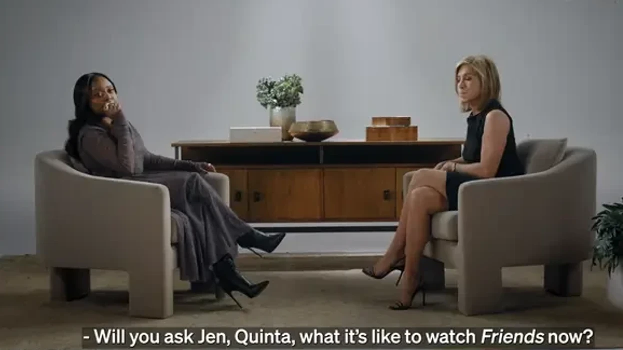 Two women sitting opposite each other, having an emotional conversation.