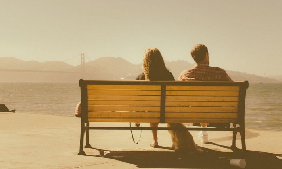 two young people on bench during the day