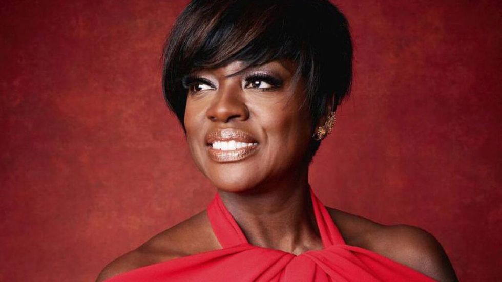 Viola Davis in red dress with a red background