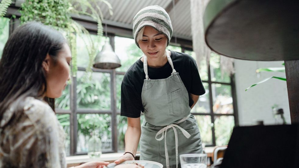 waitress serving food to a woman
