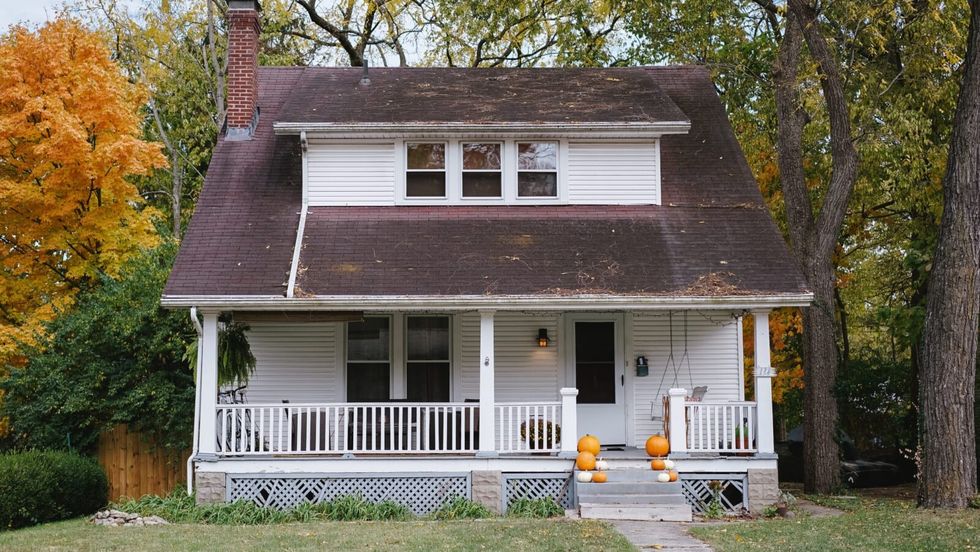 white and brown house amongst trees