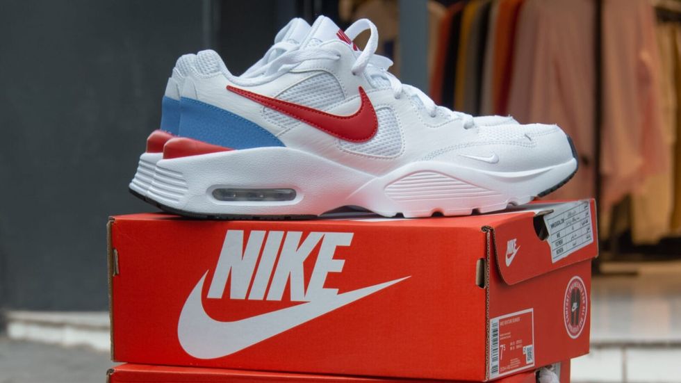 white nike shoes on an orange nike box